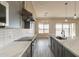 Modern kitchen featuring gray cabinets, stainless steel appliances, quartz countertops, and open space at 29380 N 231St Ave, Wittmann, AZ 85361