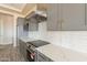 Modern kitchen featuring stainless steel appliances, quartz countertops, and a subway tile backsplash at 29380 N 231St Ave, Wittmann, AZ 85361