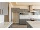 Modern kitchen featuring gray cabinets, stainless steel appliances, quartz countertops, and a subway tile backsplash at 29380 N 231St Ave, Wittmann, AZ 85361