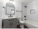 Modern bathroom with gray vanity, white subway tile, and black fixtures at 3250 W Mercer N Ln, Phoenix, AZ 85029
