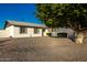 Ranch style home with front yard landscaping and large tree at 3250 W Mercer N Ln, Phoenix, AZ 85029