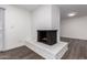 White brick fireplace in living room with dark hardwood floors at 3250 W Mercer N Ln, Phoenix, AZ 85029