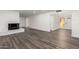 Open living room with fireplace and wood-look floors at 3250 W Mercer N Ln, Phoenix, AZ 85029