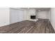 Bright and airy living room with wood-look floors and fireplace at 3250 W Mercer N Ln, Phoenix, AZ 85029