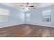 Spacious bedroom with light walls and wood-look flooring at 36532 W Barcelona Ln, Maricopa, AZ 85138