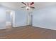 Bright bedroom with ceiling fan and access to bathroom at 36532 W Barcelona Ln, Maricopa, AZ 85138