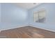 Simple bedroom with light blue walls and wood-look floors at 36532 W Barcelona Ln, Maricopa, AZ 85138