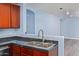 Kitchen features double sink, granite countertop, and wood cabinets at 36532 W Barcelona Ln, Maricopa, AZ 85138