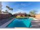 Relaxing kidney-shaped pool surrounded by a grassy lawn at 3705 W Port Royale Ln, Phoenix, AZ 85053