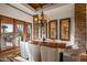 Elegant dining room with a wood table, chandelier, and stone accent wall at 40980 N 97Th St, Scottsdale, AZ 85262