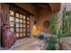Elegant entryway with a custom wood door and large pottery at 40980 N 97Th St, Scottsdale, AZ 85262