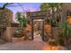 Welcoming entry with stone archway and lush desert landscaping at 40980 N 97Th St, Scottsdale, AZ 85262