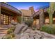Front entrance with stonework, cacti, and a tranquil water feature at 40980 N 97Th St, Scottsdale, AZ 85262