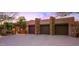 Three-car garage with stone facade and gated entry at 40980 N 97Th St, Scottsdale, AZ 85262