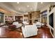 Relaxing Gathering room with a stone fireplace, comfortable seating, and wet bar at 40980 N 97Th St, Scottsdale, AZ 85262