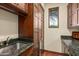 Laundry room with granite countertop, sink and built-in storage at 40980 N 97Th St, Scottsdale, AZ 85262