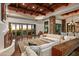Open living space with high ceilings, wood beams, and a stone fireplace at 40980 N 97Th St, Scottsdale, AZ 85262