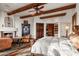 Main bedroom with fireplace, sitting area, and wood beam ceiling at 40980 N 97Th St, Scottsdale, AZ 85262