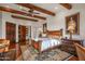 Large main bedroom with wood beam ceiling and rustic wooden bed frame at 40980 N 97Th St, Scottsdale, AZ 85262