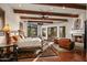 Spacious main bedroom with wood beams, fireplace, and access to patio at 40980 N 97Th St, Scottsdale, AZ 85262