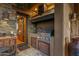 Outdoor kitchen with built-in grill and stone finishes at 40980 N 97Th St, Scottsdale, AZ 85262
