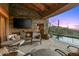 Outdoor patio features a fireplace, seating area, and stunning sunset views at 40980 N 97Th St, Scottsdale, AZ 85262