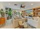 Bright living room with built-in shelving and large TV, offering comfortable seating and access to backyard at 4124 N 64Th N St, Scottsdale, AZ 85251