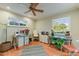 Well-lit home office featuring two desks, comfortable seating, and a ceiling fan at 4124 N 64Th St, Scottsdale, AZ 85251