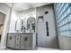 Contemporary bathroom with gray tile, double sinks, and a large walk-in shower at 41240 N Shadow Creek Ct, Anthem, AZ 85086