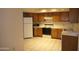 Kitchen features wood cabinets, built-in microwave, and electric range at 4210 W Calavar Rd, Phoenix, AZ 85053