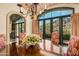 Elegant dining room with arched windows and wine cellar access at 42638 N Chiricahua Pass, Scottsdale, AZ 85262