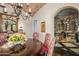 Elegant dining room with a wine cellar and ornate chandelier at 42638 N Chiricahua Pass, Scottsdale, AZ 85262