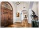 Elegant entry with herringbone floors and arched doorways at 42638 N Chiricahua Pass, Scottsdale, AZ 85262