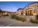 Stone facade with arched entryway and large windows at 42638 N Chiricahua Pass, Scottsdale, AZ 85262