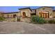 Stone house with gated entry and manicured landscaping at 42638 N Chiricahua Pass, Scottsdale, AZ 85262
