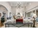 Elegant living room featuring a marble console table and chandelier at 42638 N Chiricahua Pass, Scottsdale, AZ 85262