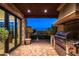 Outdoor kitchen features built-in grill, stone countertops, and a brick patio at 42638 N Chiricahua Pass, Scottsdale, AZ 85262