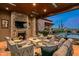 Covered patio with fireplace, seating area, and mountain views at 42638 N Chiricahua Pass, Scottsdale, AZ 85262