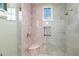 Shower with marble tile and built-in seating at 42638 N Chiricahua Pass, Scottsdale, AZ 85262