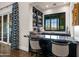 Home bar with black marble top and liquor shelving at 42638 N Chiricahua Pass, Scottsdale, AZ 85262