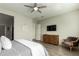 Spacious bedroom with wood floors, large TV, and comfortable seating at 4506 S Eastern Run, Mesa, AZ 85212