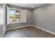 Bright bedroom featuring wood-look floors and white shutters at 4532 E Grandview Rd, Phoenix, AZ 85032