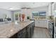 Modern kitchen with white cabinets, granite island, and stainless steel appliances at 4532 E Grandview Rd, Phoenix, AZ 85032