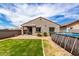 Backyard boasts a covered patio, lush green grass, and refreshing above ground pool, ideal for outdoor living at 5013 S 112Th Ave, Tolleson, AZ 85353