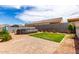 Relaxing backyard features an above ground pool, green grass and a brick patio, perfect for outdoor enjoyment at 5013 S 112Th Ave, Tolleson, AZ 85353