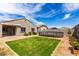 Spacious backyard featuring a lawn, above-ground pool, covered patio with a bench, and desert landscaping at 5013 S 112Th Ave, Tolleson, AZ 85353
