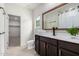 Bathroom featuring a modern vanity with a large mirror, white countertop, and tile flooring at 5013 S 112Th Ave, Tolleson, AZ 85353