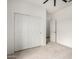 Bedroom features a closet with sliding doors and a view of an open doorway to another room at 5013 S 112Th Ave, Tolleson, AZ 85353