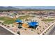 Aerial view of the Verde Trails Community featuring a park, playground, and vast open spaces in the landscape at 5013 S 112Th Ave, Tolleson, AZ 85353