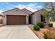 Charming single-story home featuring a two-car garage and well-maintained desert landscaping in front yard at 5013 S 112Th Ave, Tolleson, AZ 85353